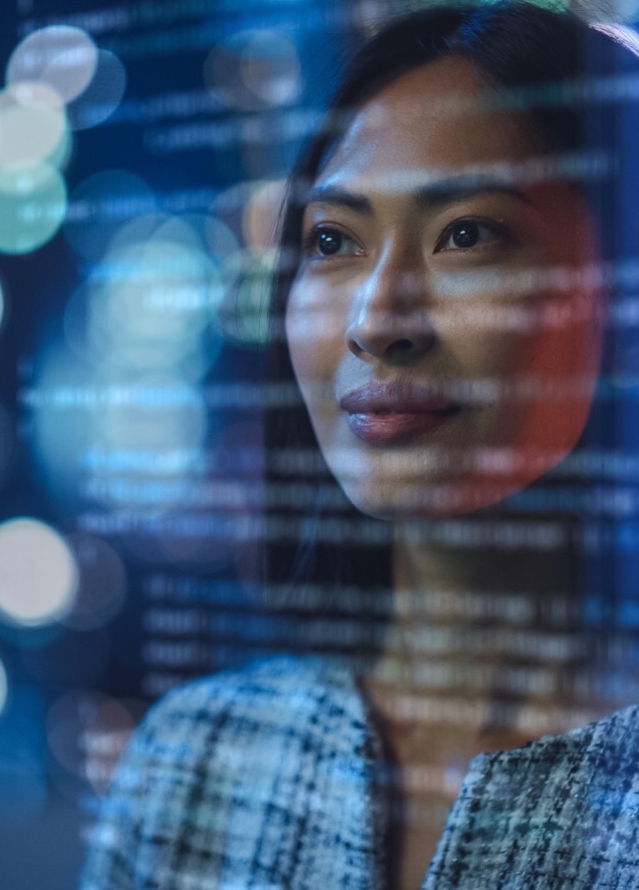 Software engineer with data visualised on screen