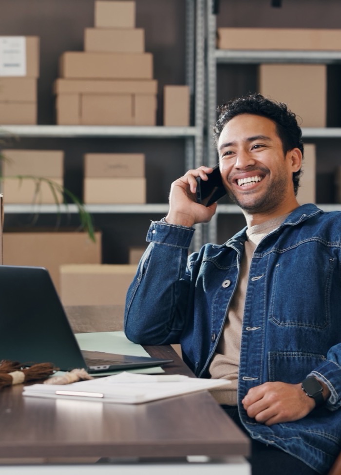 Founder taking a call in an e-commerce fulfilment warehouse