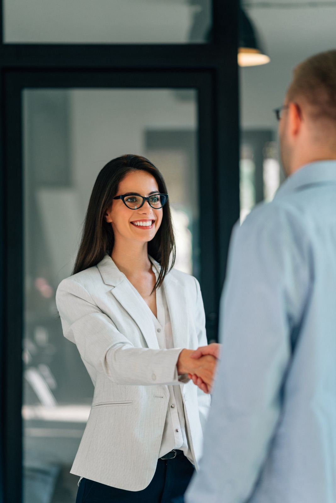 Adviser greeting a client in an office doorway
